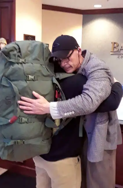 The proud father and Veteran David Haave gives a hug to a soldier going overseas 2016 -- David Haave